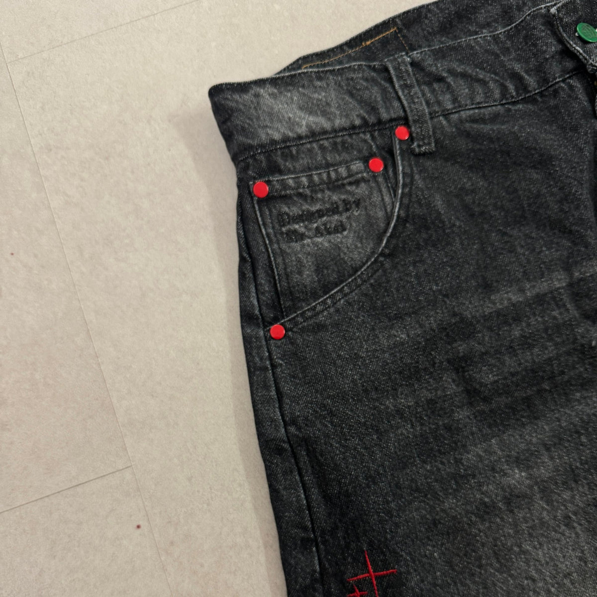 'DYNAMIGHT' Baggy Jeans - front pocket with red rivets and embossed 'Designed by Mr Akai' detail