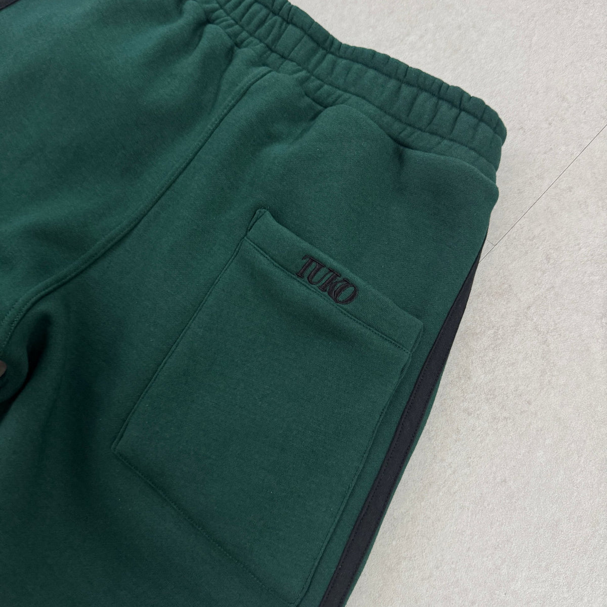 'DEKU' Baggy Sweatpants - back pocket with embroidered TUKO logo