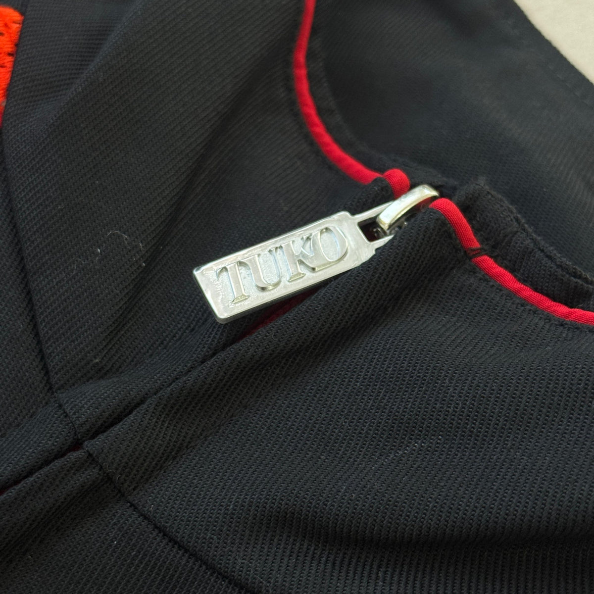 'HELLFIRE' Tech Jacket - TUKO zip puller detail