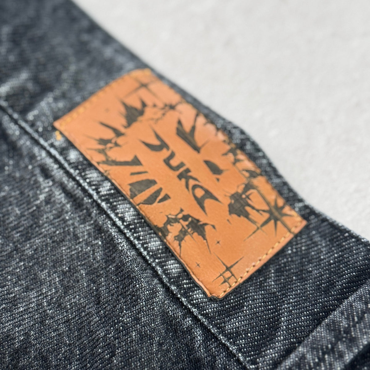 'DYNAMIGHT' Baggy Jeans - leather TUKO patch detail