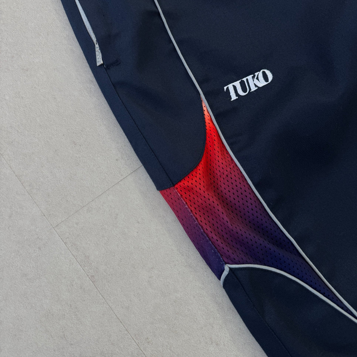 'HOT / COLD' Track Pants - TUKO logo and gradient mesh panel detail